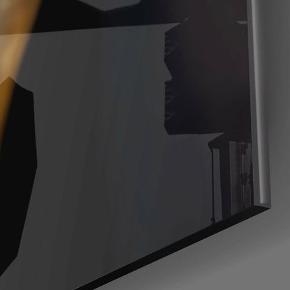 Angled side view of glass wall art panel showing silhouetted profile design with black frame edge against gray background.
