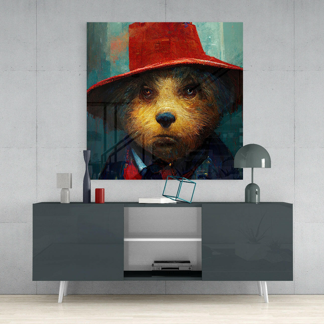 Glass wall art depicting a dog wearing a red hat against a teal background, displayed above a gray media console in a modern interior setting.