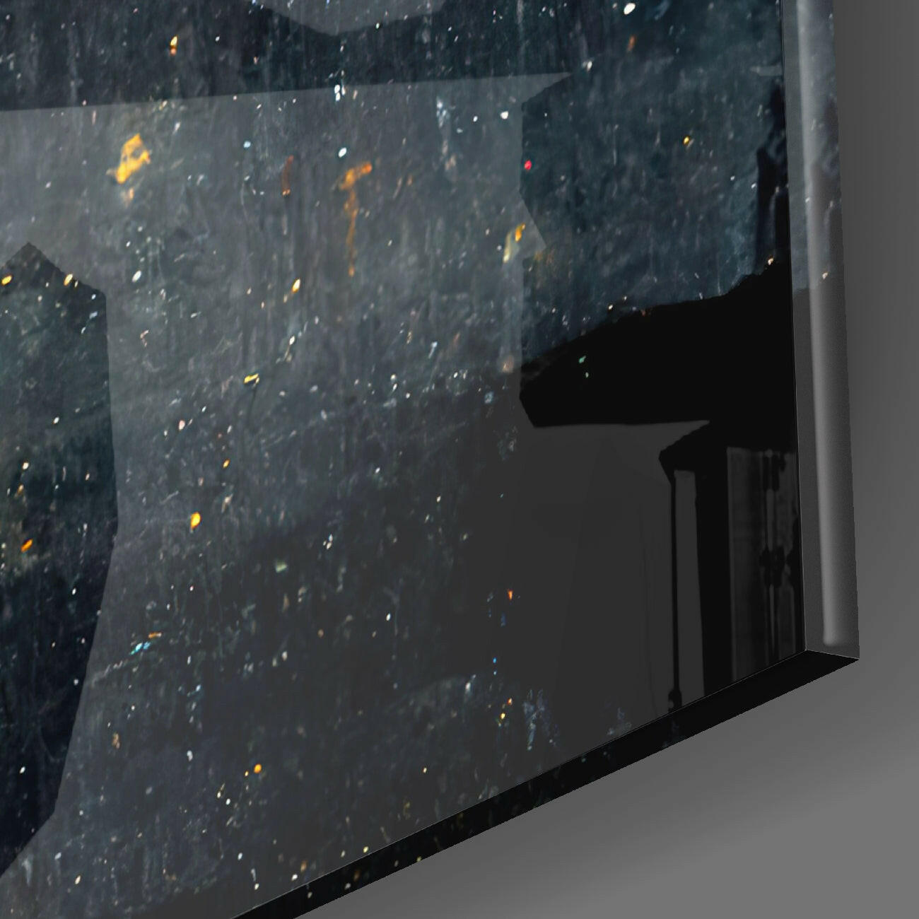 Close-up angled view of Star Rain Glass Wall Art showing spattered gold and white paint details on dark glass surface with white frame edge visible.