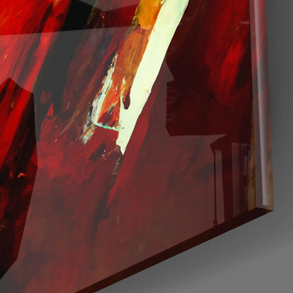 Close-up angled view of translucent red glass wall art with white and golden brushstroke details against gray background.