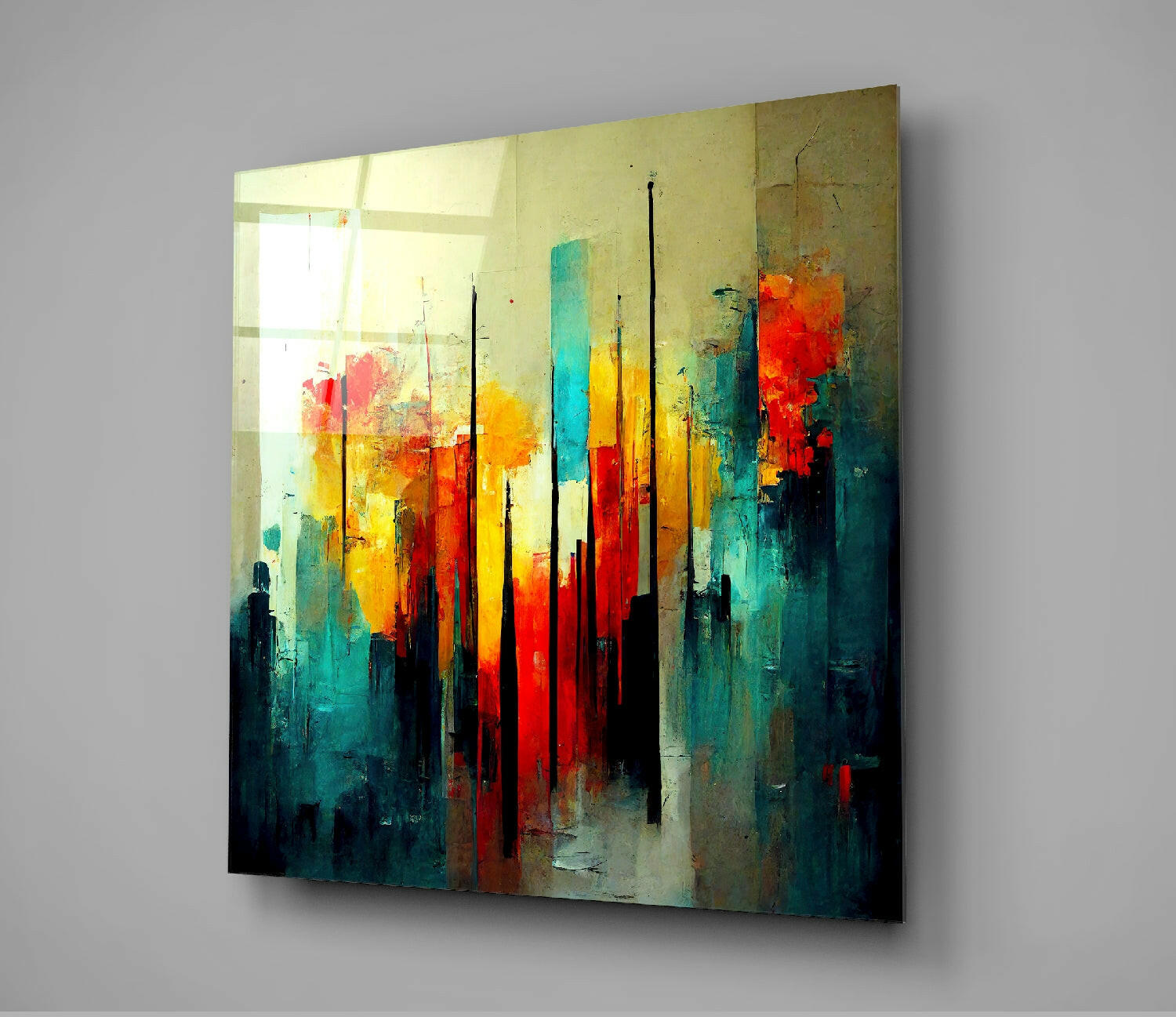 Abstract glass wall art featuring vertical black lines overlaid on vibrant yellow, red, orange, and teal brushstrokes, displayed at an angle against gray wall.