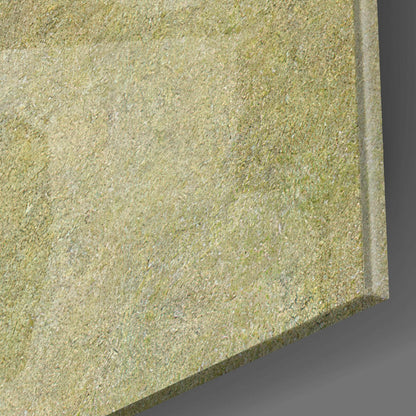 Close-up detail of textured glass surface showing granular beige and cream speckled finish with beveled edge.