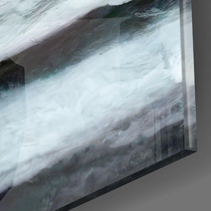 Close-up angled view of Master Glass Wall Art showing turbulent white water and dark rocky terrain printed on translucent glass panel with black frame edge.