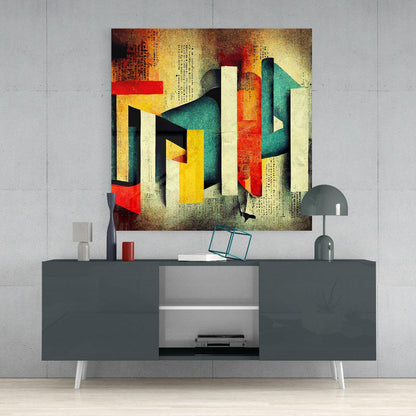 Colorful abstract glass wall art with geometric shapes in red, yellow, teal, and cream displayed above a gray media console in a modern interior setting.