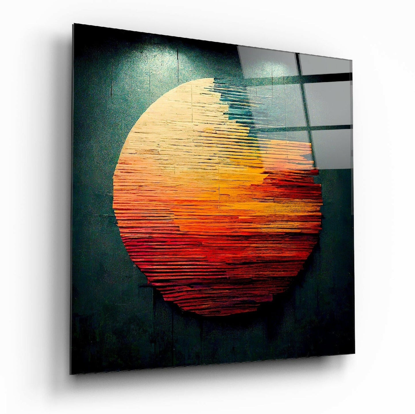 Angled perspective of glass wall art displaying a layered circular sun design in cream, orange, and red wood textures against a dark teal background.