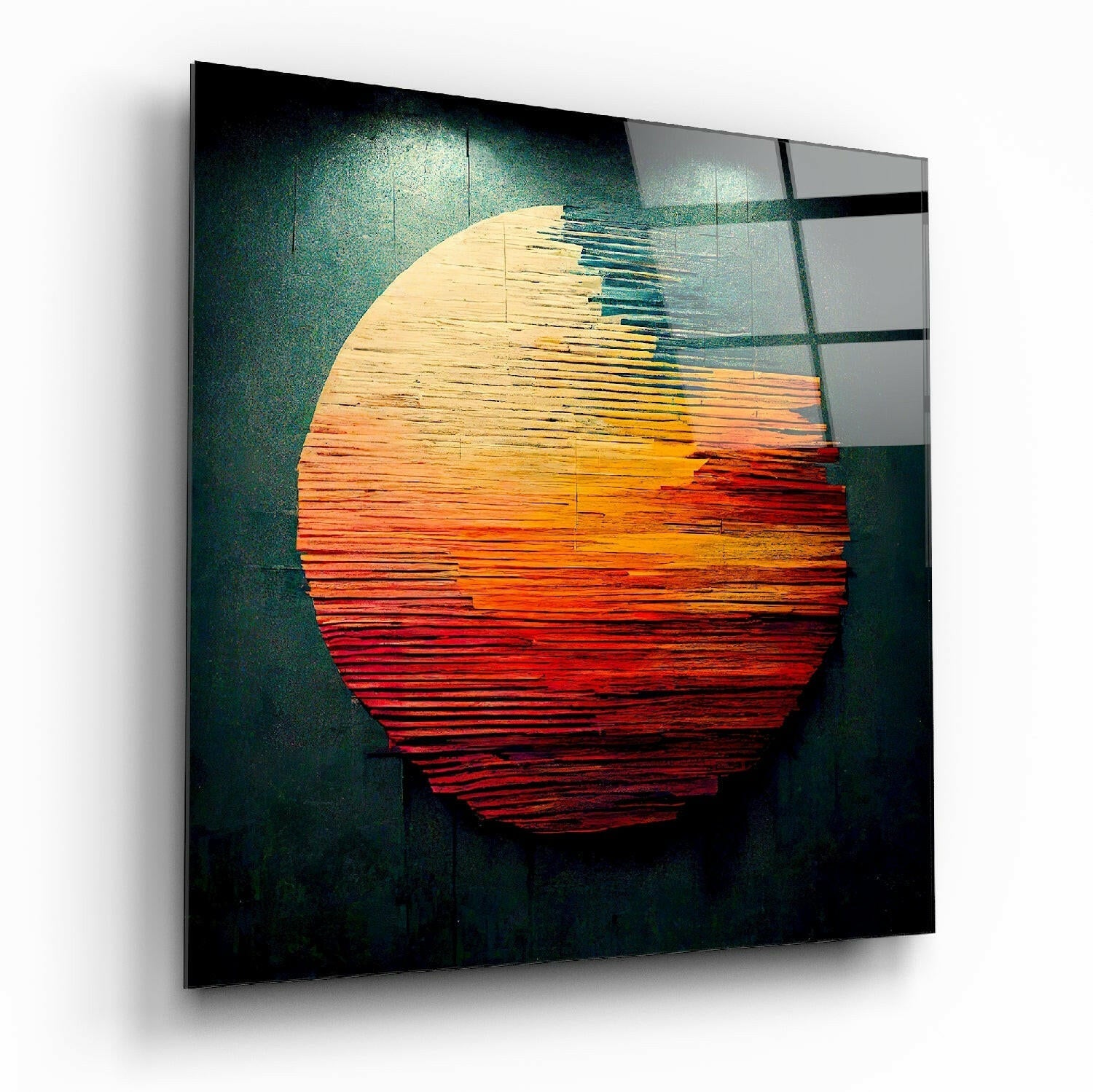 Angled perspective of glass wall art displaying a layered circular sun design in cream, orange, and red wood textures against a dark teal background.