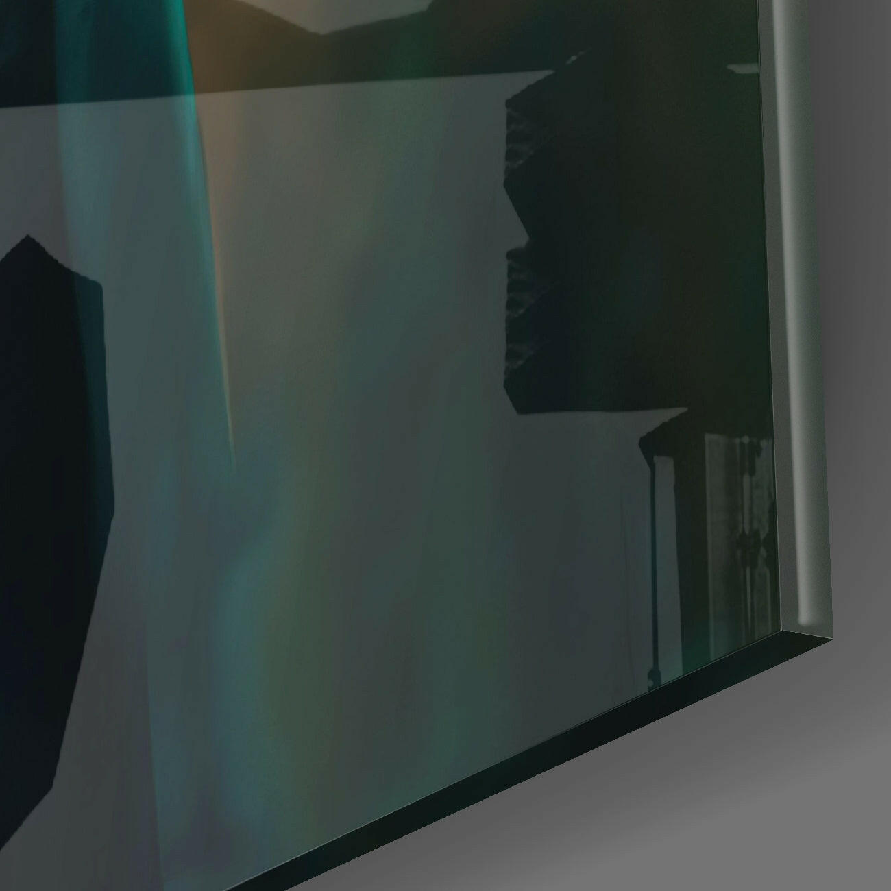 Close-up angled view of frosted glass wall art panel showing teal and green gradient coloring with dark silhouette detail.