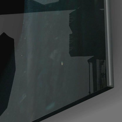 Close-up angled view of frosted glass wall art showing silhouetted beak profile against dark teal background with black frame edge.