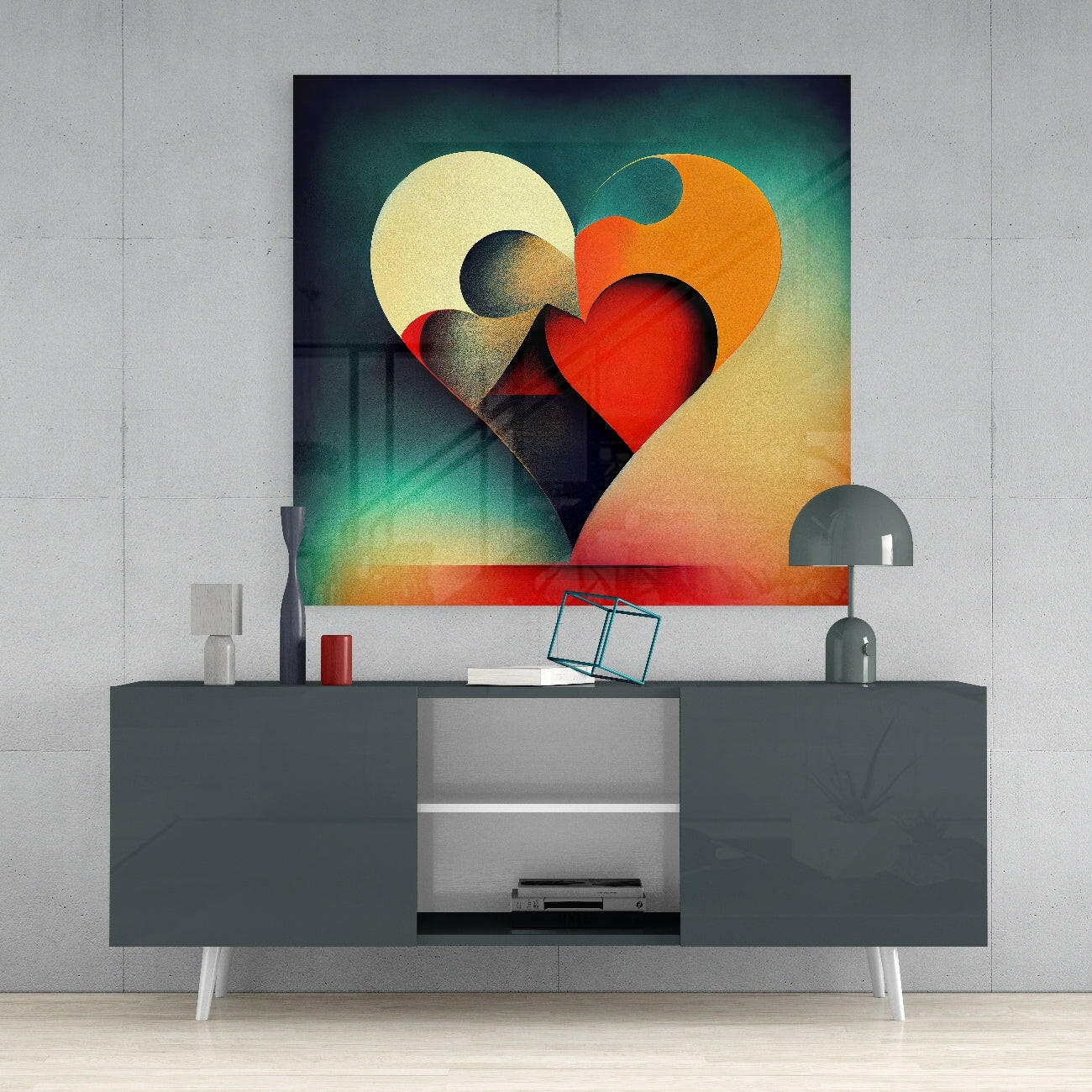 Colorful abstract heart glass wall art displayed above a dark gray media console with white legs and decorative accessories.