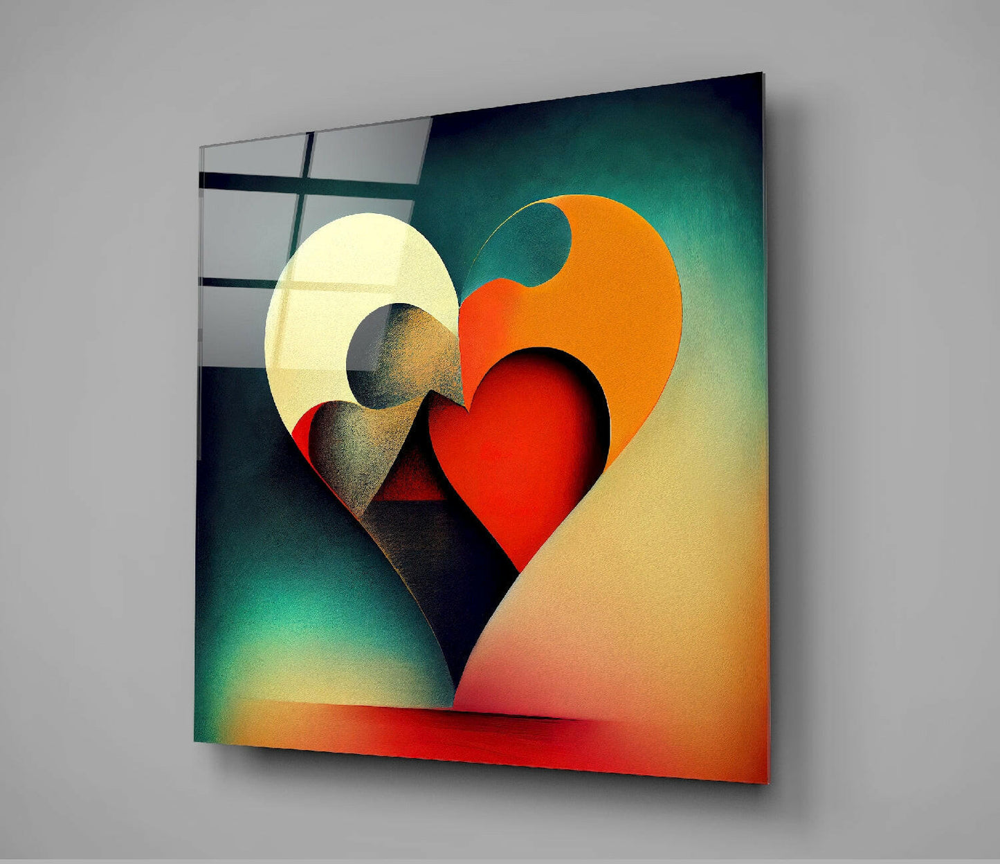 Layered glass wall art featuring overlapping hearts in cream, orange, and red against a teal-to-yellow gradient background, displayed at an angle on a gray wall.
