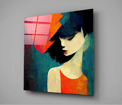 Square glass wall art mounted at angle showing stylized portrait of woman in profile wearing orange hat and red shirt against teal and cream background with pink geometric grid pattern on left side.