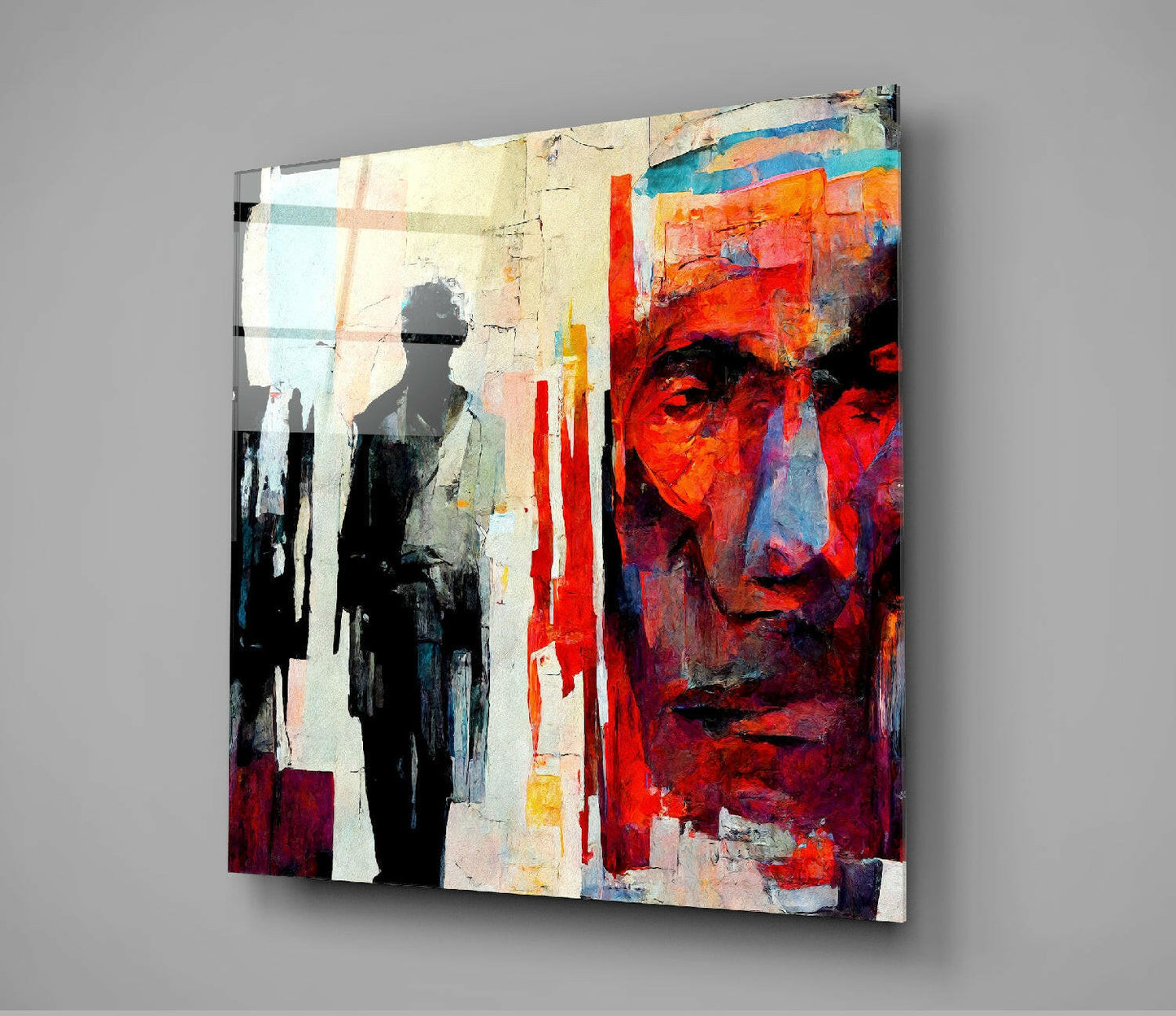 Modern glass wall art featuring abstract portrait in vibrant reds, oranges, and blacks with silhouetted figure, angled product view.