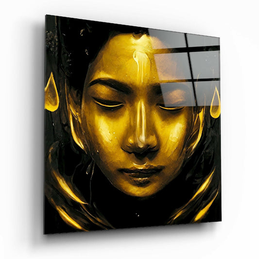 Gold-faced goddess sculpture with closed eyes on black glass panel, featuring illuminated gold leaf details and geometric line overlay.