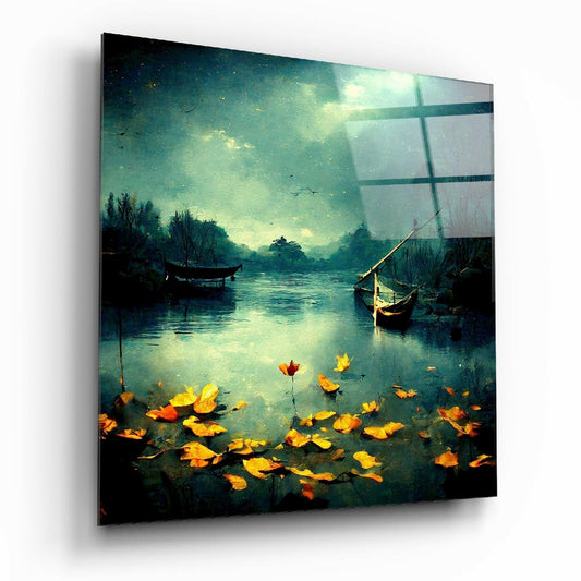 Glass wall art panel displaying a moody autumn landscape with boats on water, golden leaves, and ethereal teal-green lighting, shown at an angle.