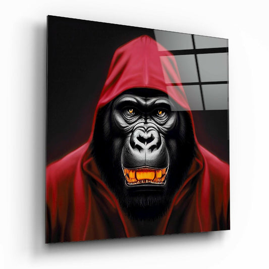 Angled product view of glass wall art featuring a menacing black gorilla in a red hoodie with glowing golden eyes and orange teeth against a dark background.