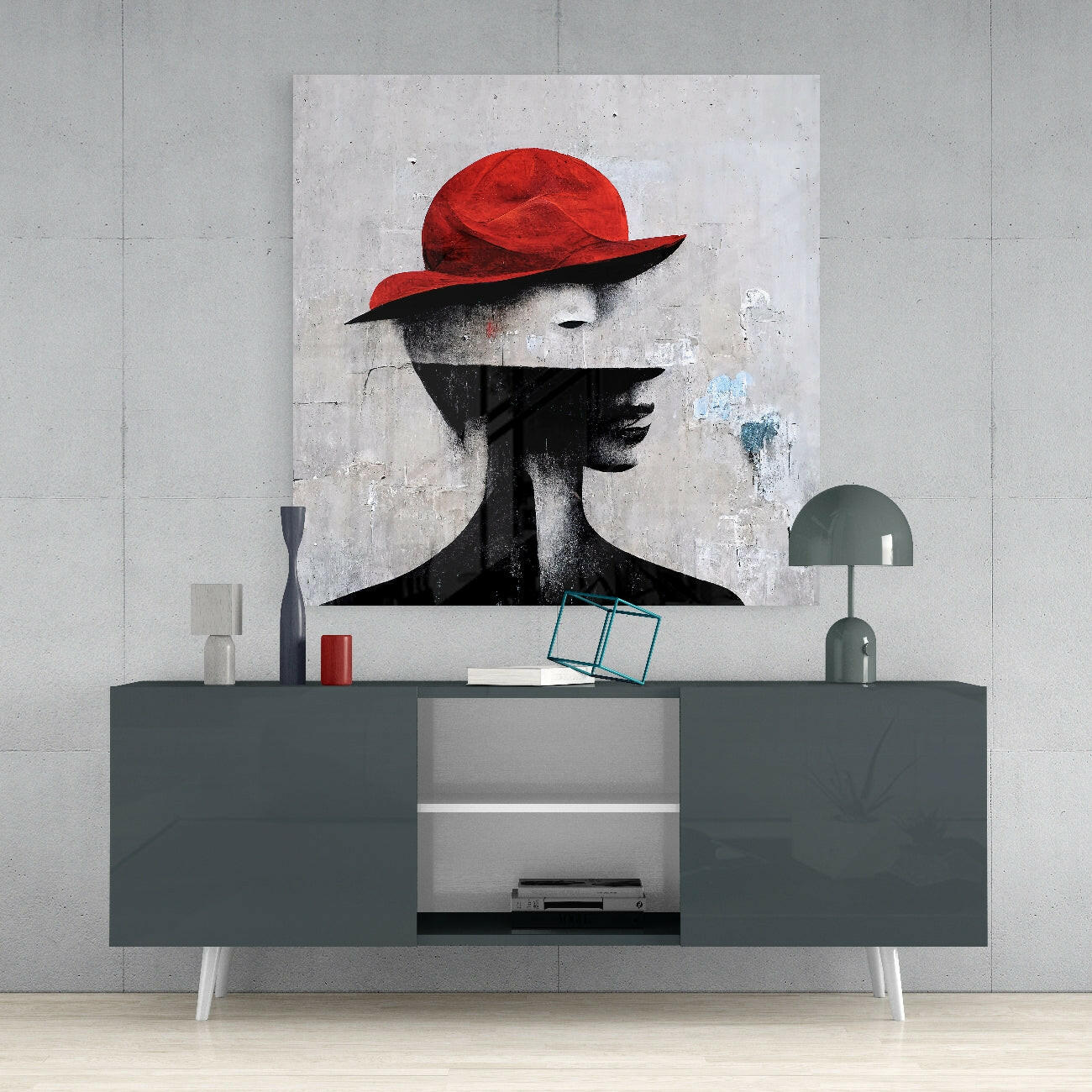 Modern living room display featuring a gray media console with a red and black silhouette portrait artwork mounted above.