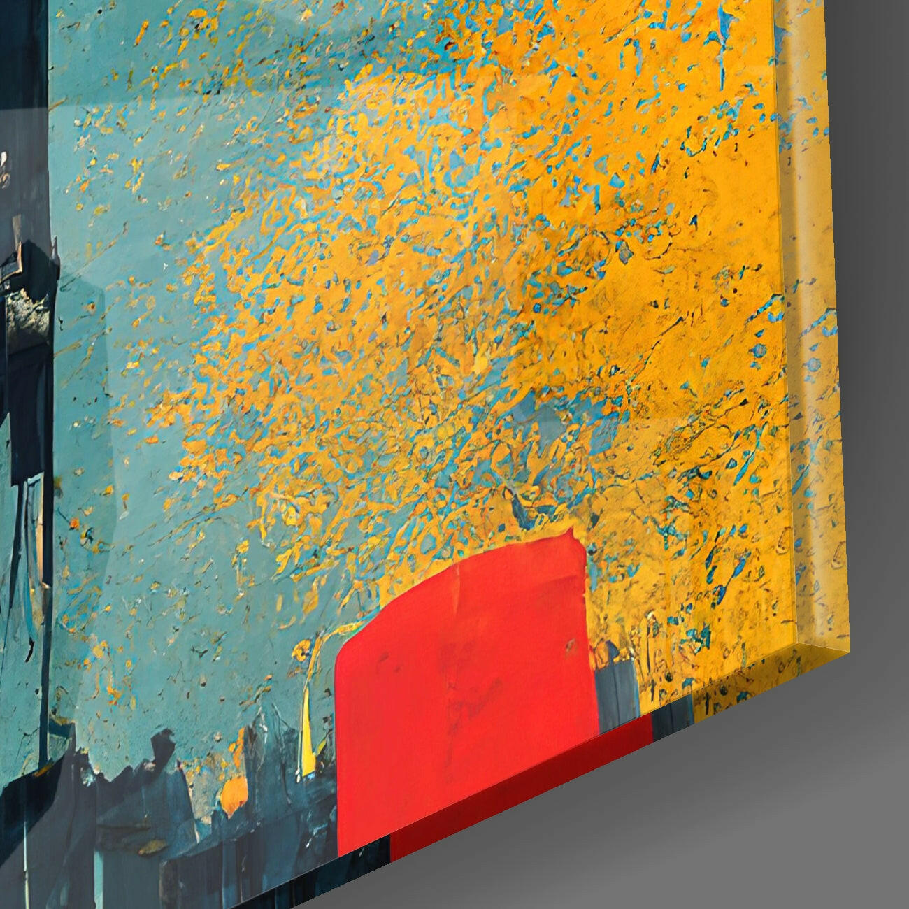 Angled view of glass wall art featuring distressed turquoise and yellow paint texture with bright red geometric shape at bottom.