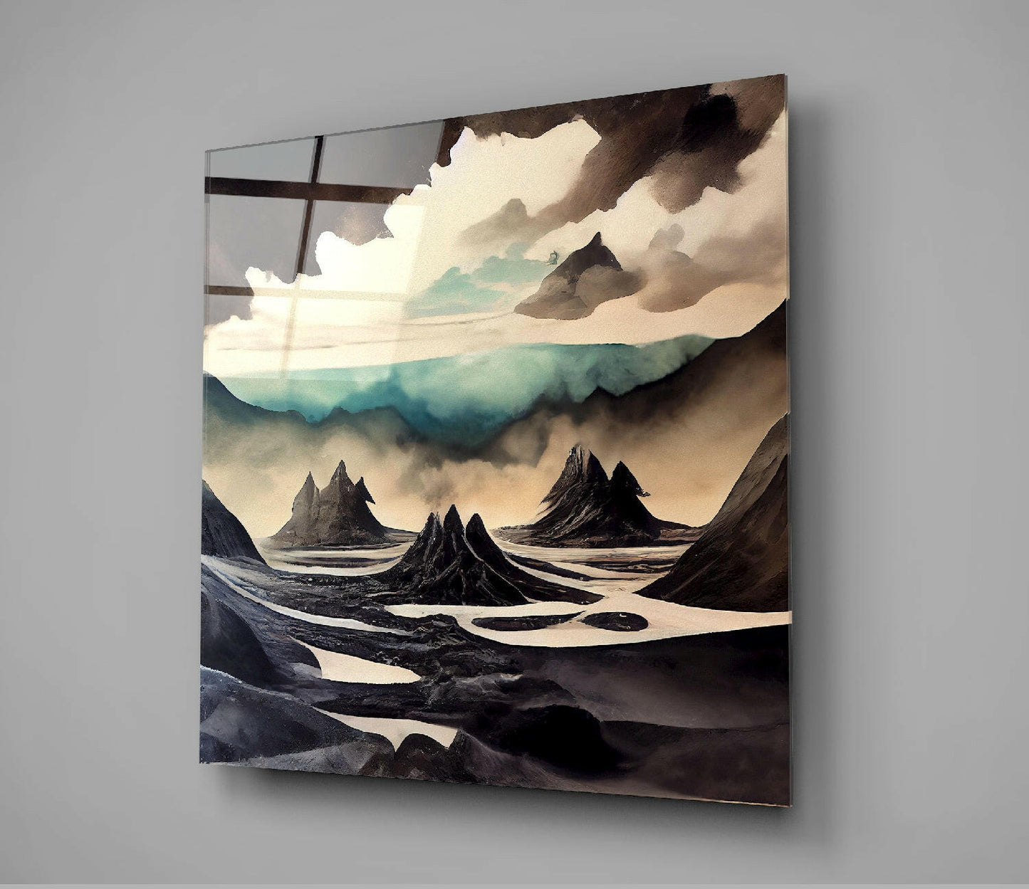 Glass wall art displaying an otherworldly landscape with dark volcanic peaks, cream and turquoise tones, and dramatic cloudy sky.