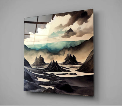 Glass wall art displaying an otherworldly landscape with dark volcanic peaks, cream and turquoise tones, and dramatic cloudy sky.