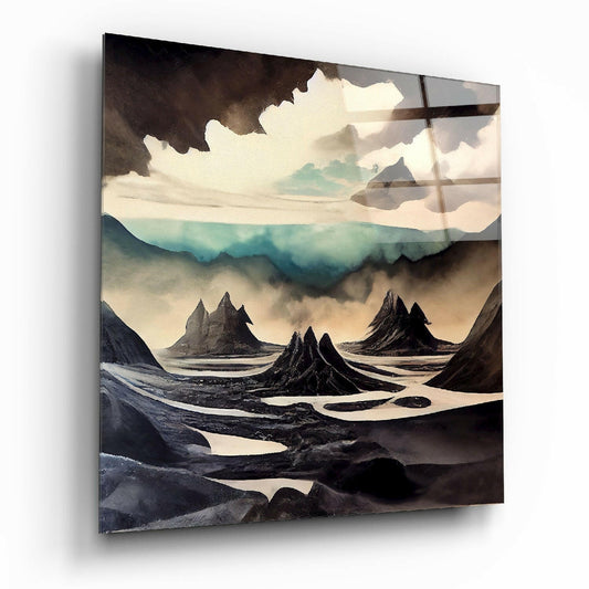 Surreal landscape glass wall art depicting dramatic black volcanic peaks beneath cream clouds with turquoise mountains, displayed at an angle.