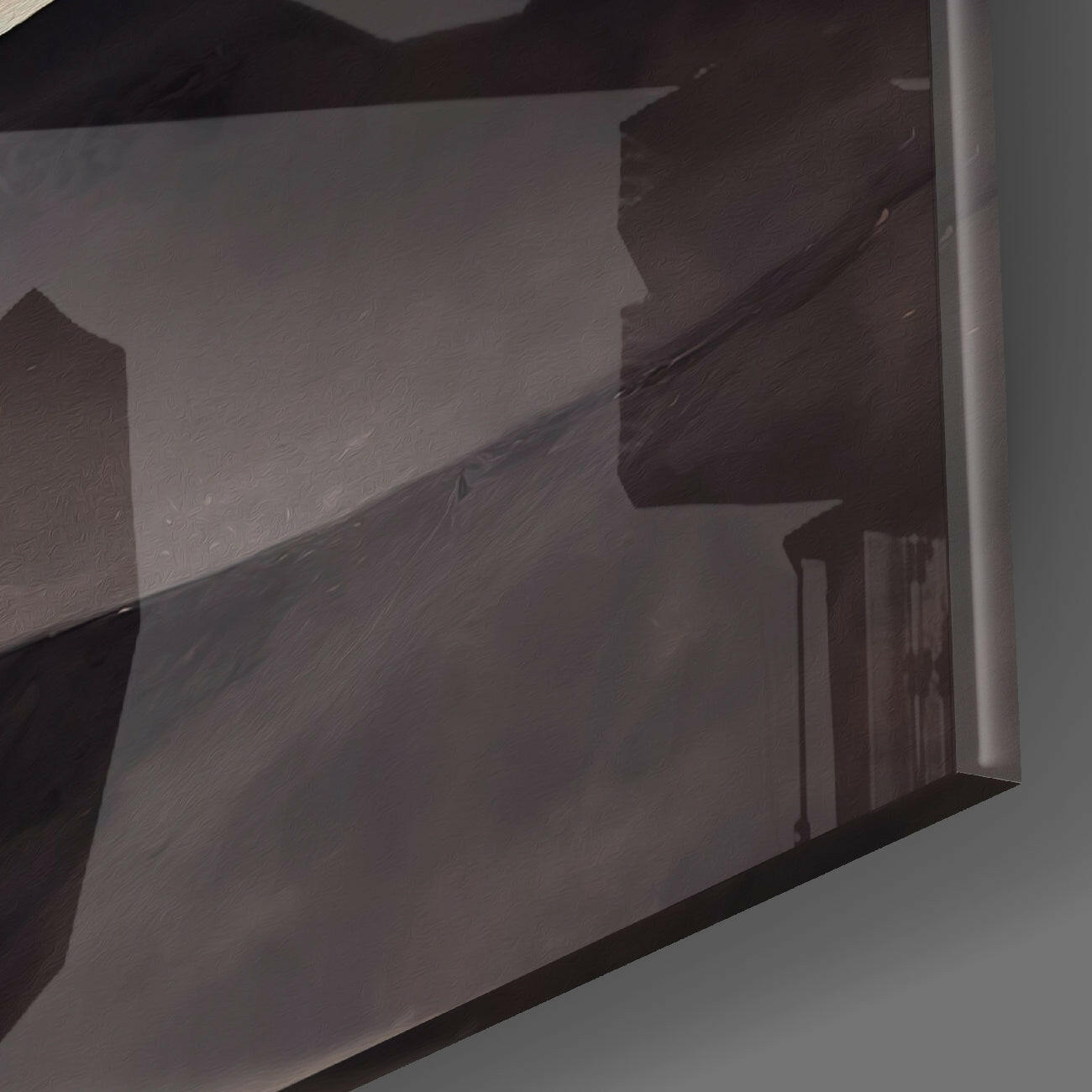 Close-up angled view of dark brown landscape glass wall art showing textured surface and edge detail against white background.