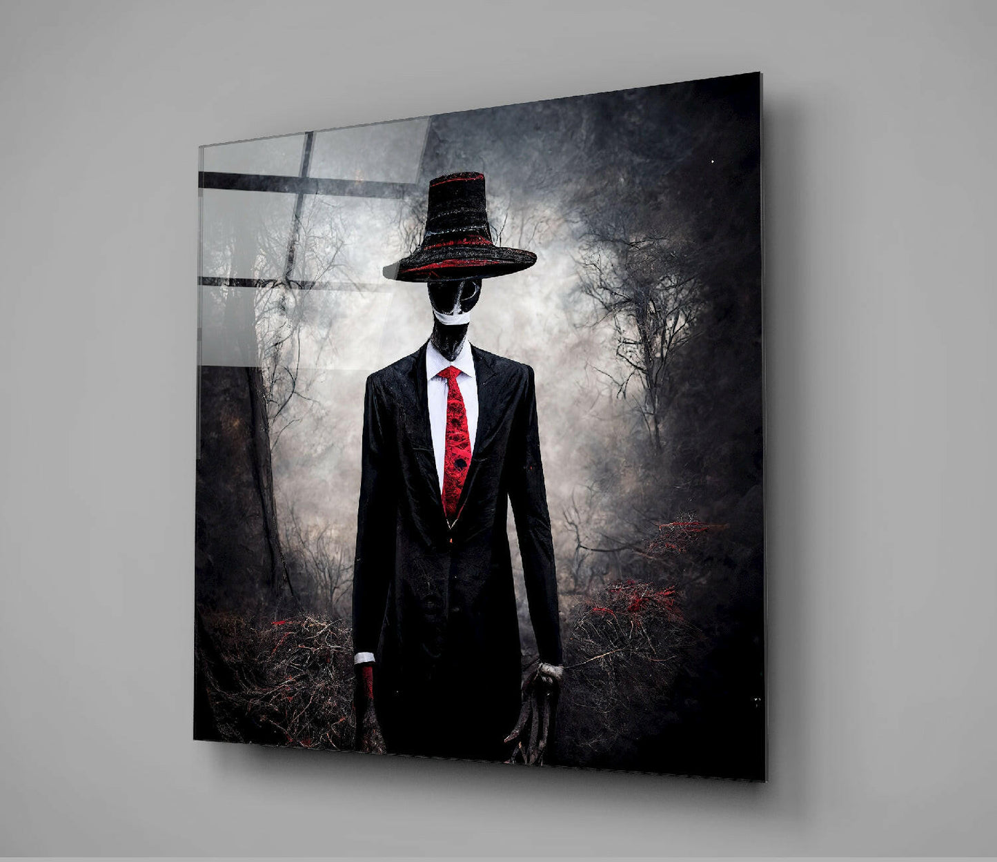 Glass wall art displaying a suited figure with obscured face wearing a black hat with red trim and matching red tie against a dark forest background.