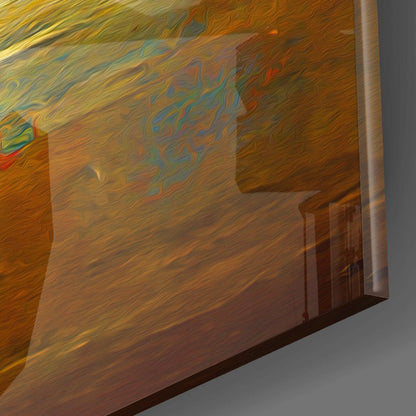 Close-up angled view of glass wall art showing warm amber and golden tones with fluid blue and red swirled patterns, right edge visible with metal frame.