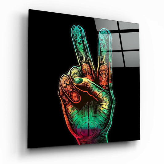 Angled view of glass wall art displaying a neon-colored peace hand gesture with anatomical details against black background.