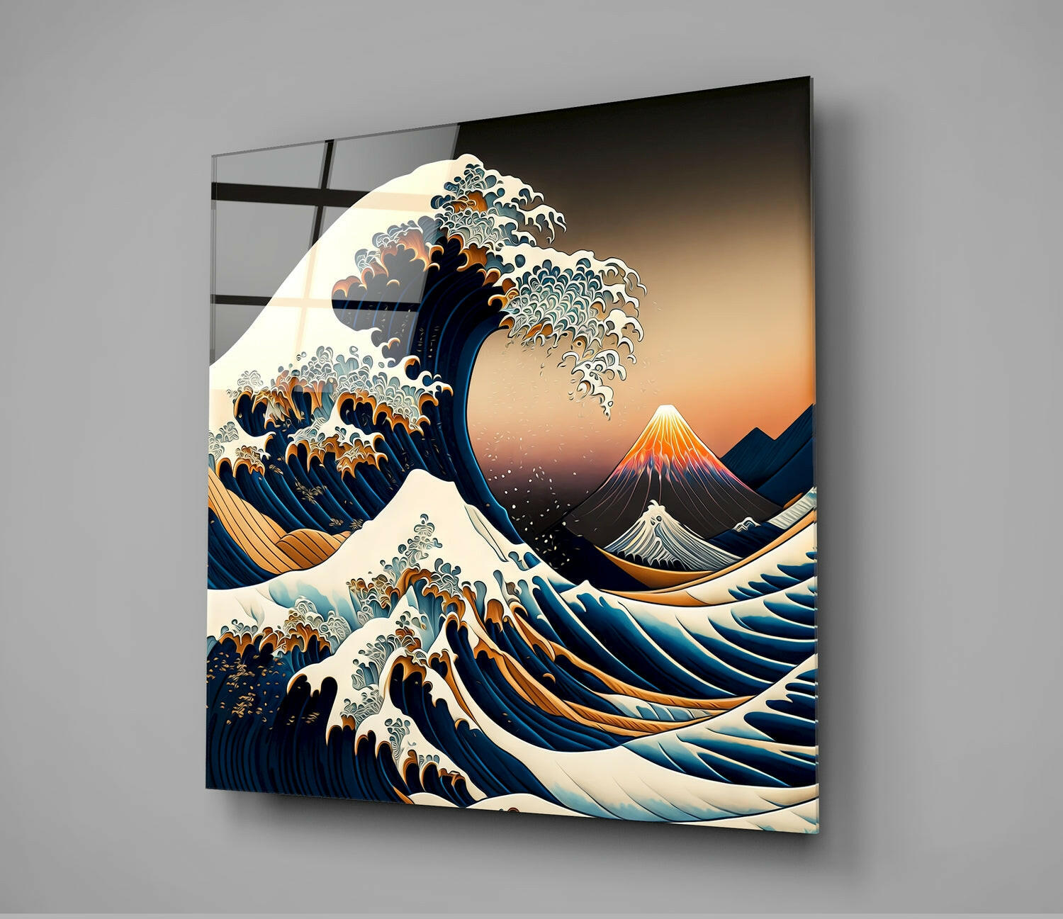 Mounted glass wall art displaying Japanese-inspired wave design with orange sunset, snow-capped volcano, and deep blue water against gray wall.