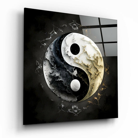 Three-dimensional yin-yang glass wall art displayed at an angle, showing swirling black and white marbled surfaces with gold accents and a grid-patterned dark background.