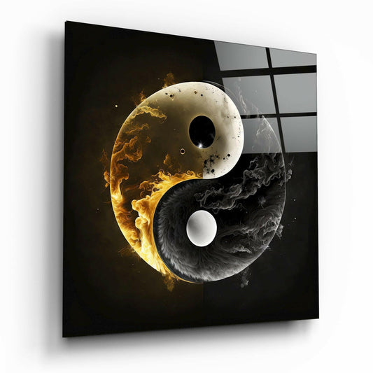 Glass wall art displaying a yin yang symbol with golden flames on the light side and black smoke on the dark side, shown at an angle.