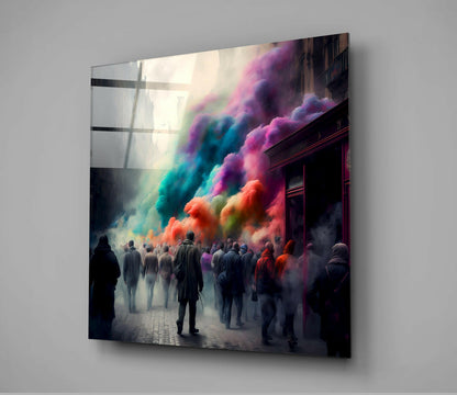 Glass wall art mounted on gray wall showing silhouetted figures in urban street scene with vibrant rainbow-colored powder clouds billowing overhead.