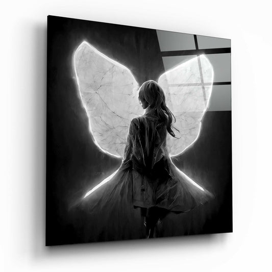 A girl with long hair viewed from behind wearing a tulle skirt, illuminated by glowing white neon butterfly wings against a dark background on glass.