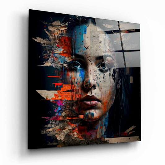 Glass wall art panel displaying a stylized woman's face with blue eyes, overlaid with red and blue newsprint collage fragments and abstract geometric elements.