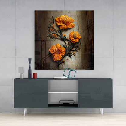 Orange flowers on dark branches displayed as glass wall art above a gray media console in a modern interior setting.