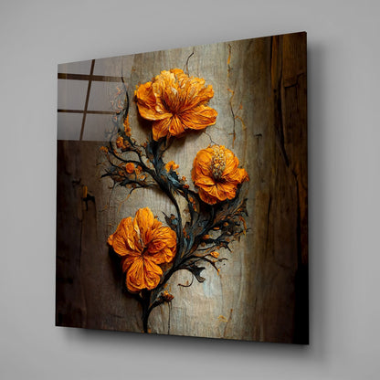 Three vibrant orange flowers on a dark twisted branch against a weathered gray textured wall, displayed as angled glass wall art.
