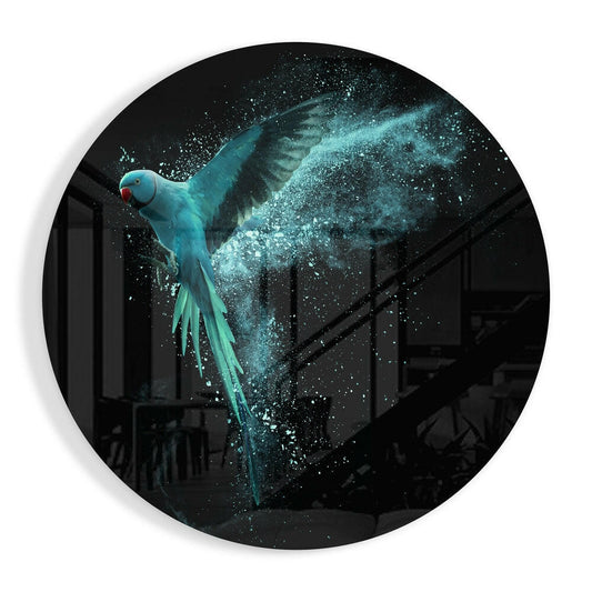 Circular glass wall art featuring a turquoise parrot in flight with dispersing sparkle particles against a dark interior backdrop.