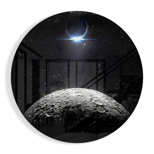 Circular glass wall art displaying a cratered moon in foreground with starfield and glowing planet eclipse in background, viewed through dark architectural framework.