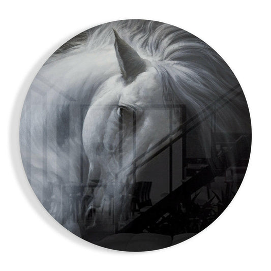 White horse in profile with bowed head on circular glass art, dark stable background visible below.
