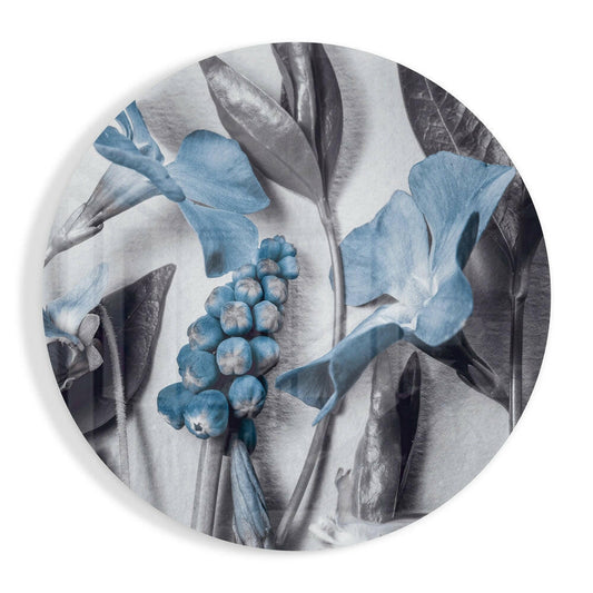 Round glass wall art featuring blue flowers with gray foliage in botanical illustration style on white background.