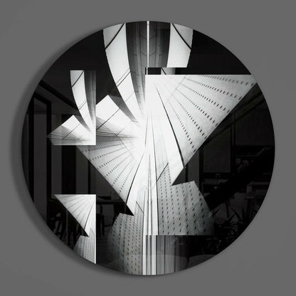 Black and white circular glass wall art featuring upward-looking architectural photograph of modern skyscrapers converging toward sky.