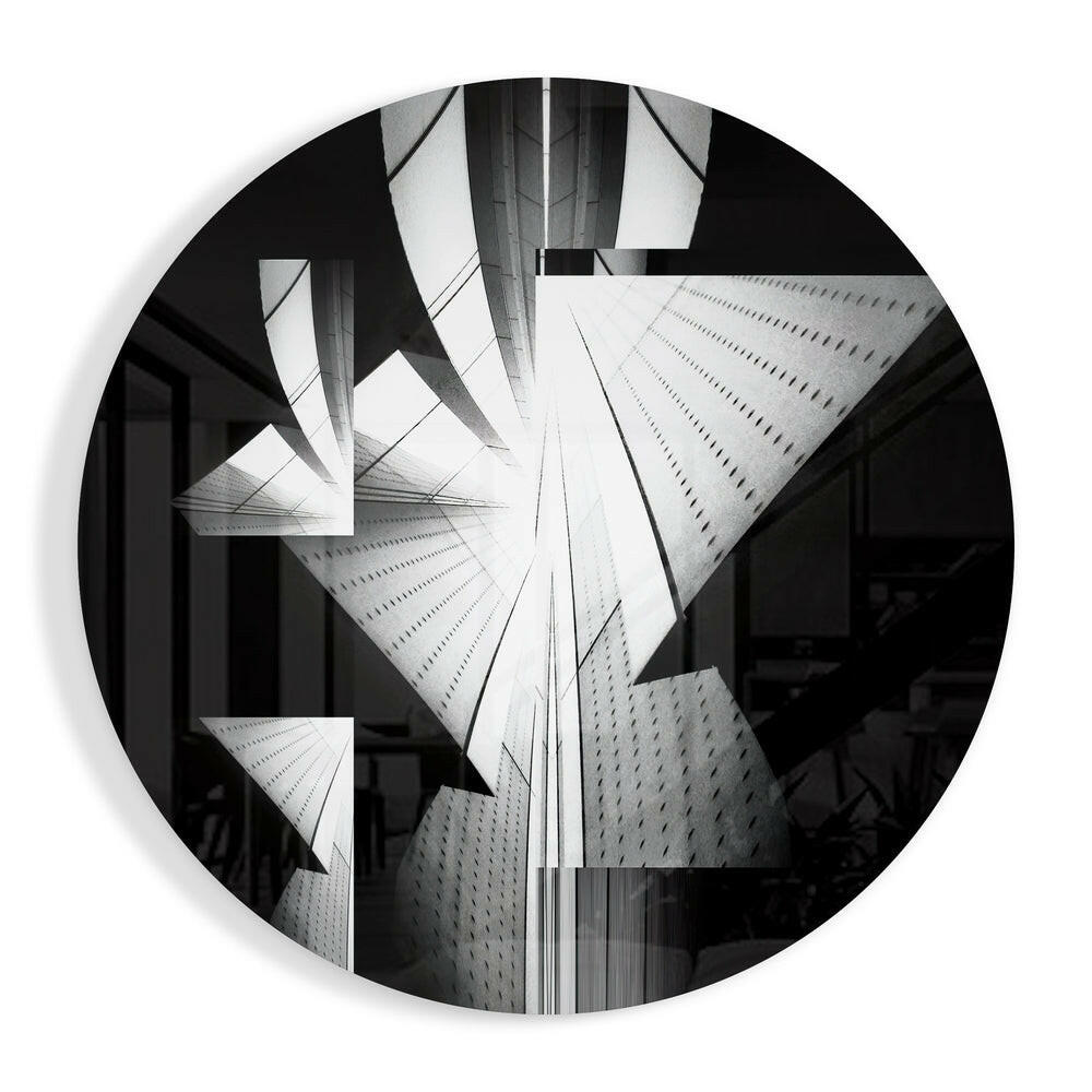 Black and white photograph of tall skyscrapers shot from below, displayed on a circular glass wall art piece.