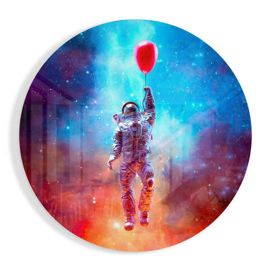 Astronaut in spacesuit holding red balloon floating upward through colorful nebula gradient from orange below to blue above on circular glass panel.