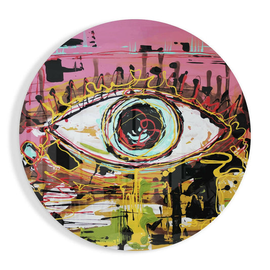 Circular glass wall art featuring a colorful eye design with pink background, yellow lightning bolts, red iris, and black drip details.