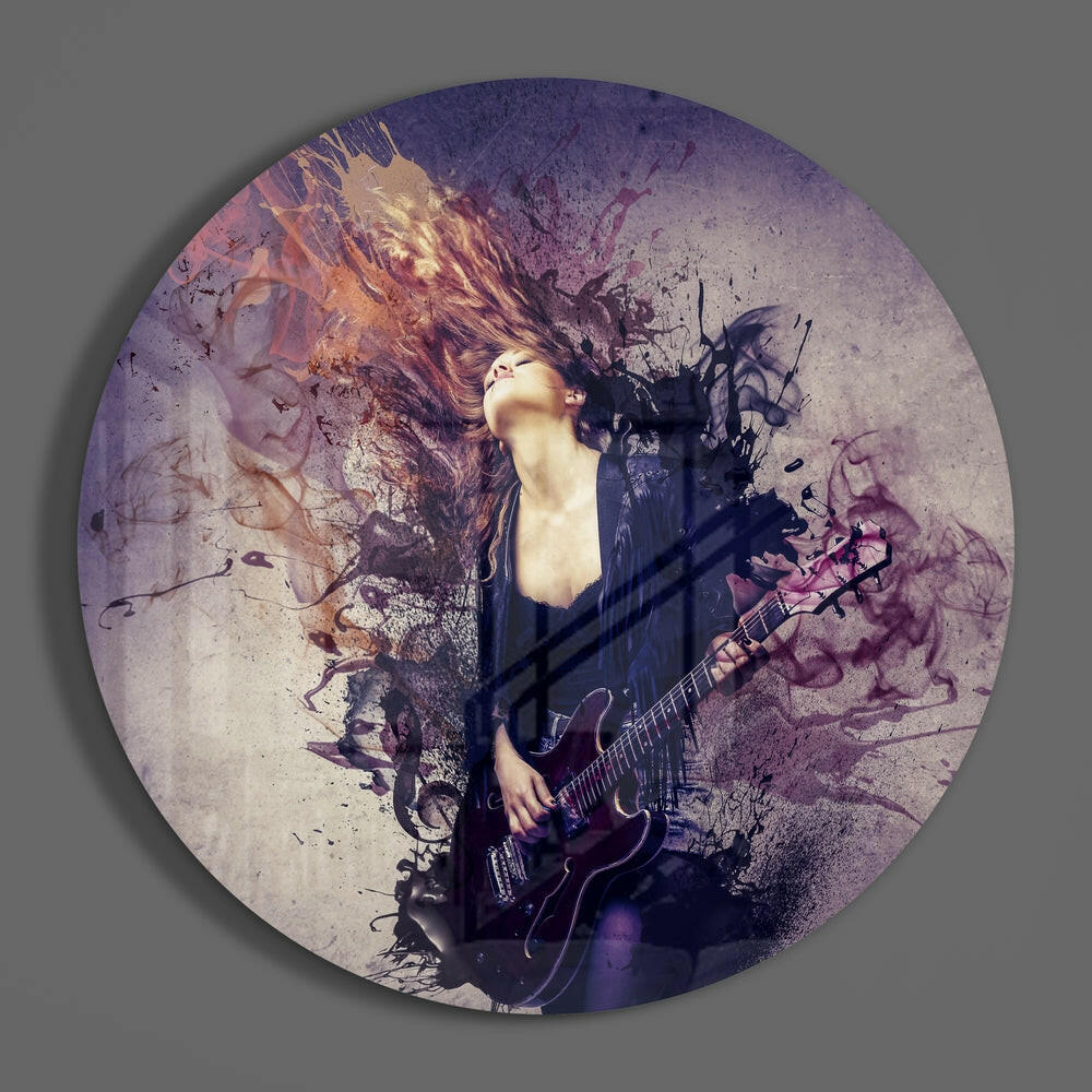 Circular glass art featuring a musician with flowing hair playing guitar, surrounded by purple and gold watercolor splatter effects on a textured background.