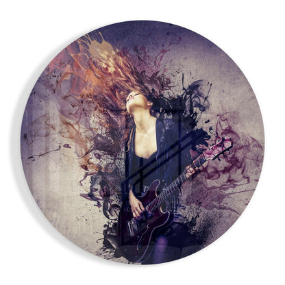 Circular glass wall art featuring a musician with long hair playing electric guitar, overlaid with purple and gold watercolor splatter effects and abstract ink dispersions.