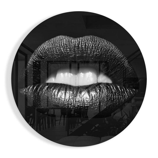 Black and white close-up of glossy lips with textured surface mounted on circular glass wall art, interior space visible behind.
