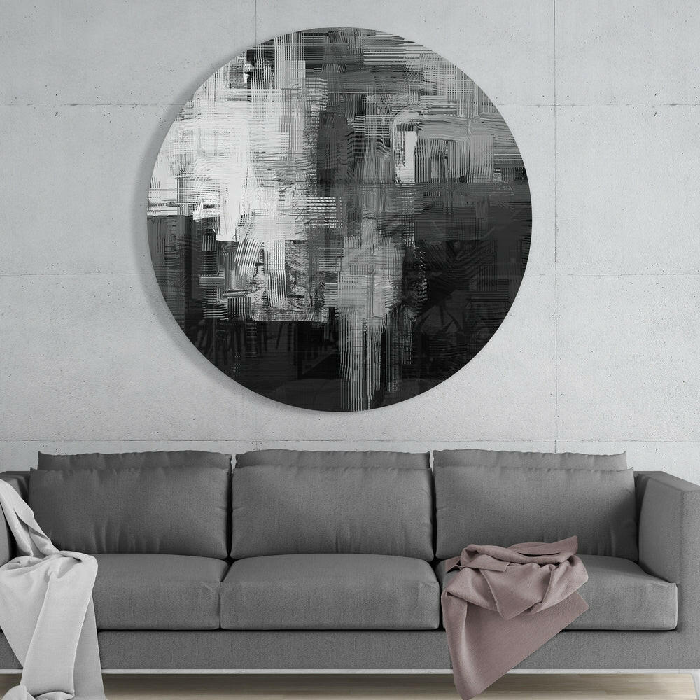Modern living room interior with gray sofa beneath circular abstract glass wall art featuring black and white striped pattern.