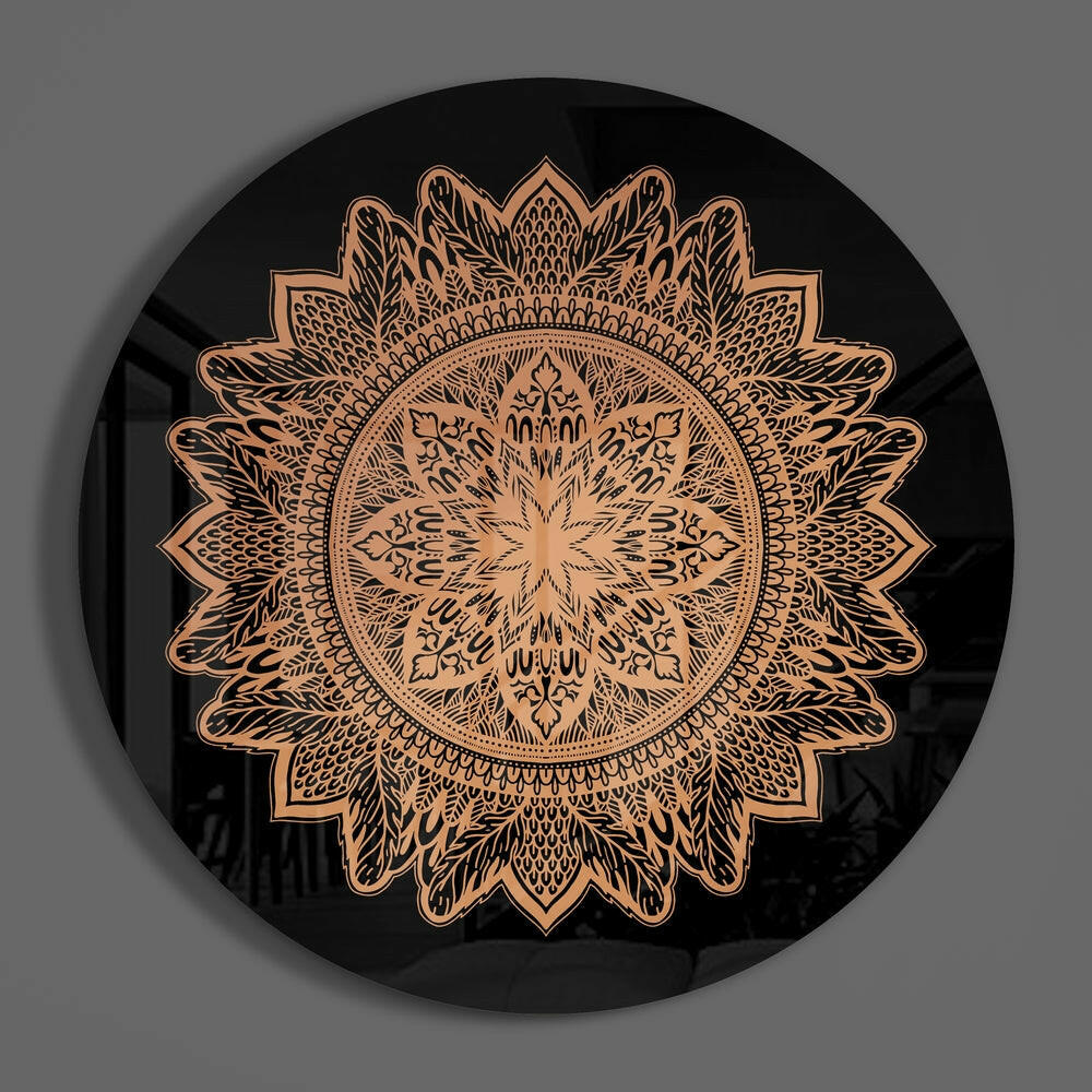 Black circular glass wall art featuring an intricate copper-colored mandala flower pattern, photographed straight-on against gray background.