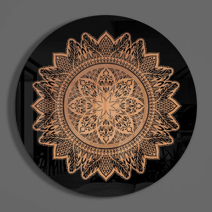 Black circular glass wall art featuring an intricate copper-colored mandala flower pattern, photographed straight-on against gray background.